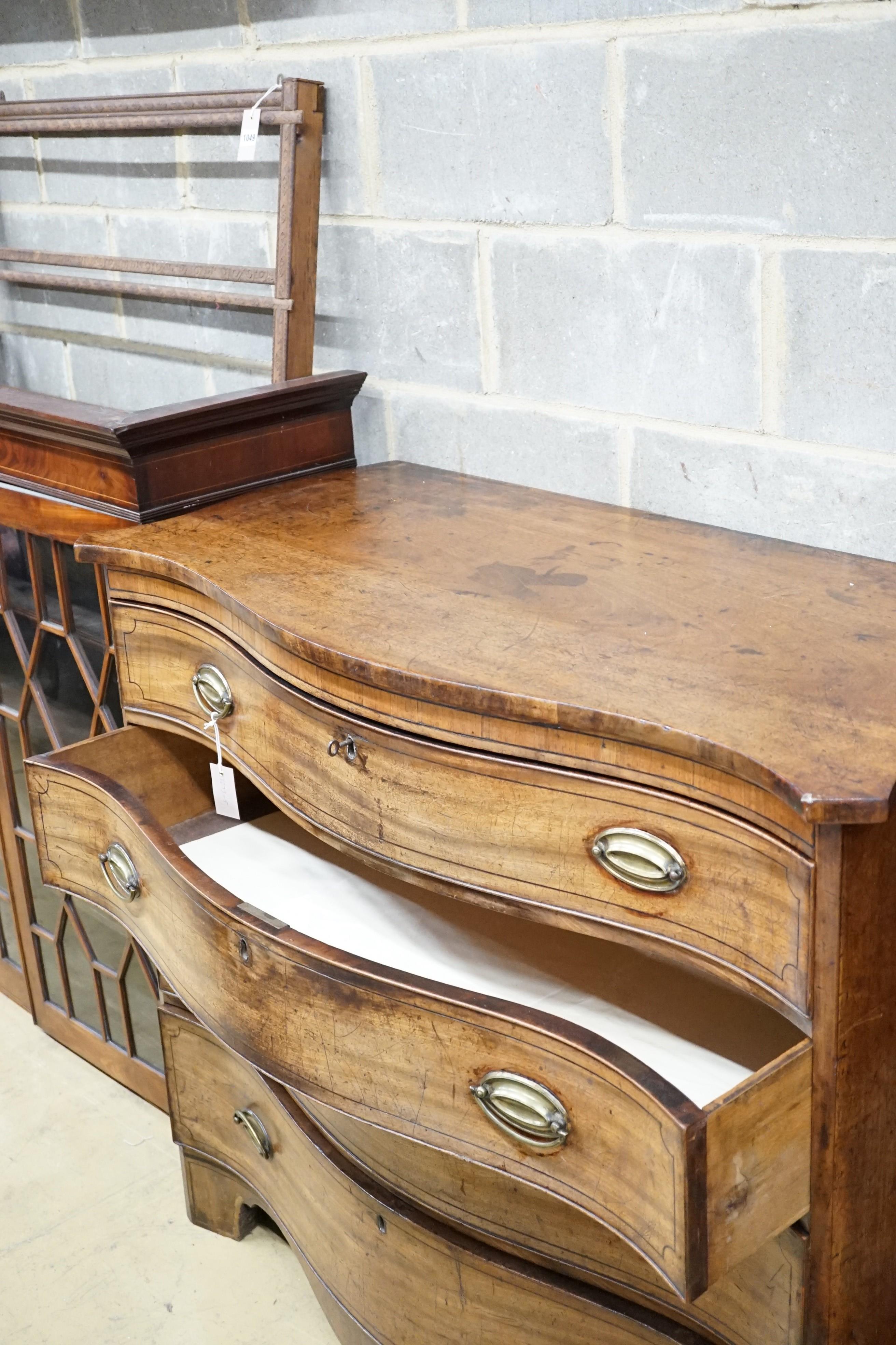 A George III mahogany serpentine chest with ebony stringing and four graduated long drawers, the top drawer divided into three, width 120cm, height 104cm, depth 59cm